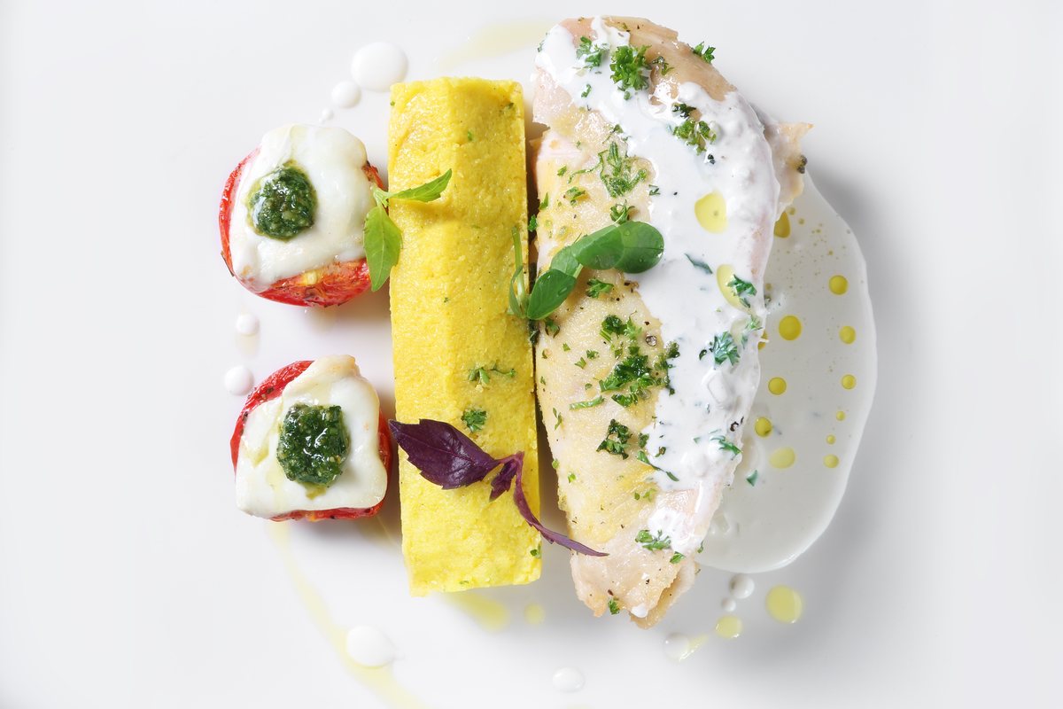 Herb-crusted fillet with polenta and stuffed tomatoes