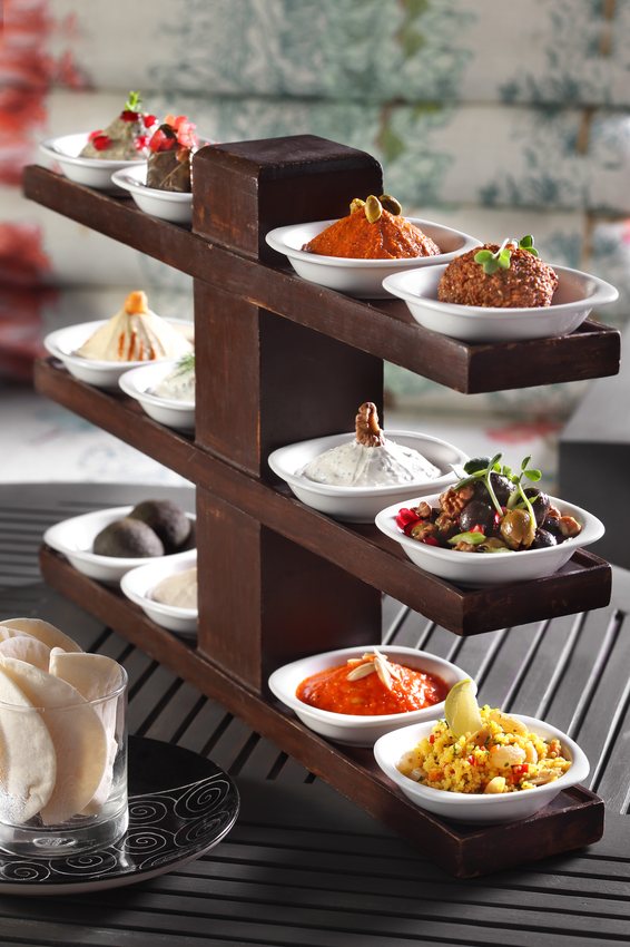 Tiered mezze selection with dips and small plates