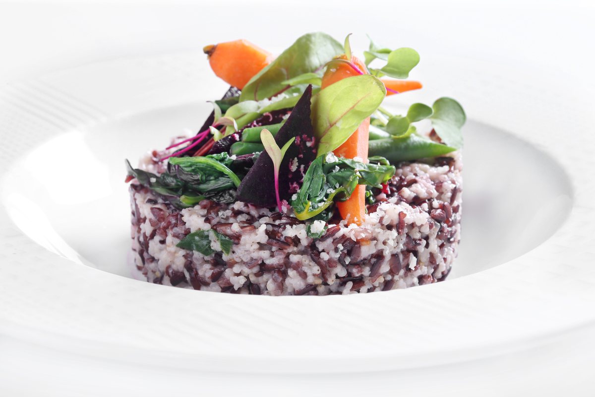 Contemporary black rice and millet timbale with garden vegetables