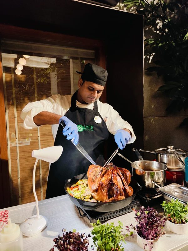 Chef plating food at a live event station